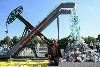 Canadian artist and activist Benjamin Von Wong at the unveiling of his art installation "Perpetual Plastic Machine" on the banks of the Seine River in Paris on May 27, 2023, to support the Global Plastics Treaty (Photo by Bertrand GUAY / AFP) (Photo by BERTRAND GUAY/AFP via Getty Images)